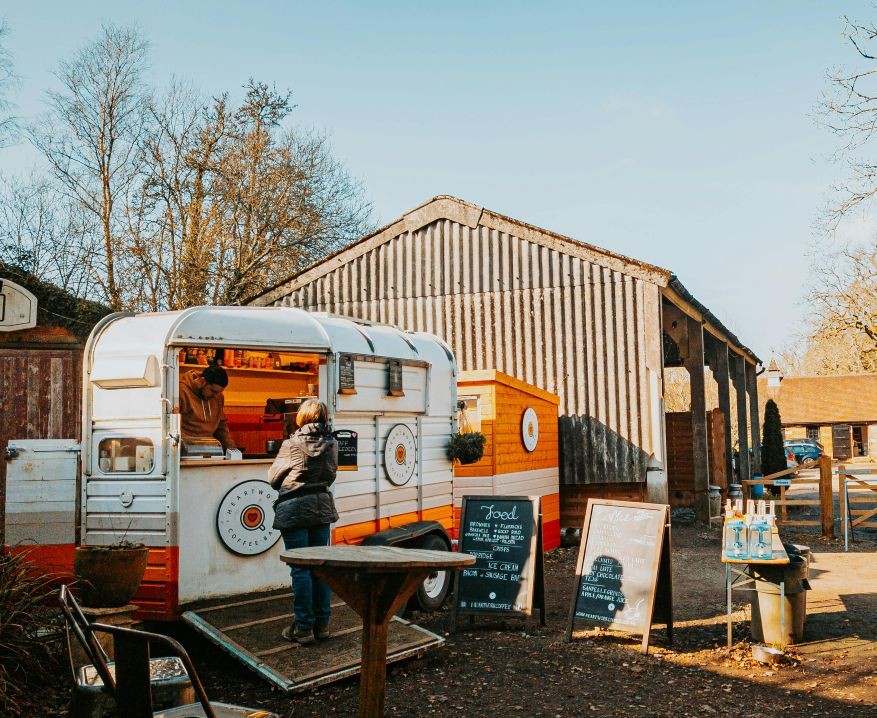 A food trailer serving cafe drinks and cakes in the farm yard. Photo by Ryan Collis.